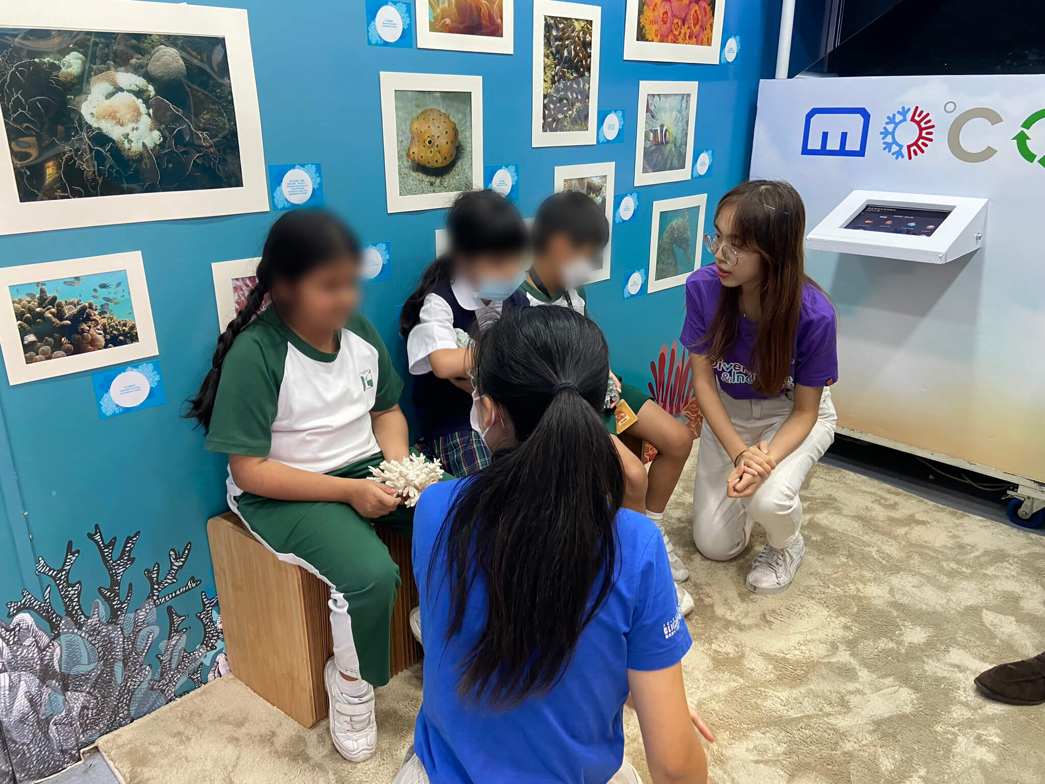 The Diversity and Inclusion Ambassador is introducing the students from Ebenezer School to the Jockey Club Museum of Climate Change mobile truck.