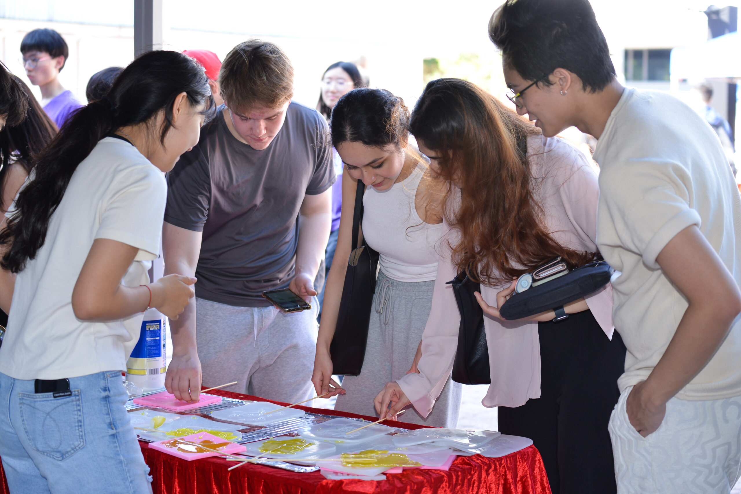 Four participants gathering and engaging in the Sugar Painting Workshop.