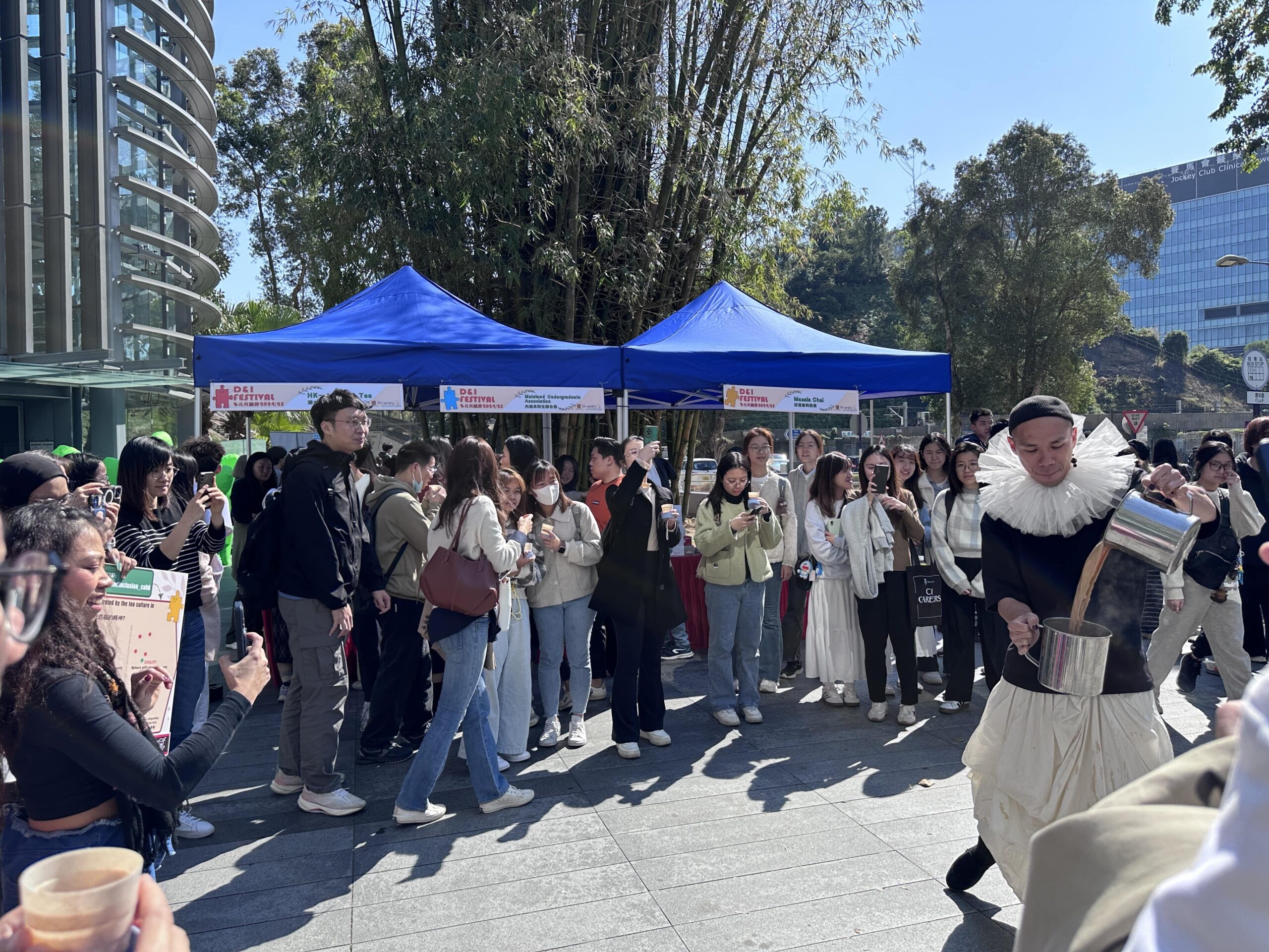 A large crowd of captivated spectators is eagerly watching the mesmerizing tea-pulling performance, marveling at the skill and artistry of the tea master as they expertly stretch and pour the tea with graceful, fluid movements.